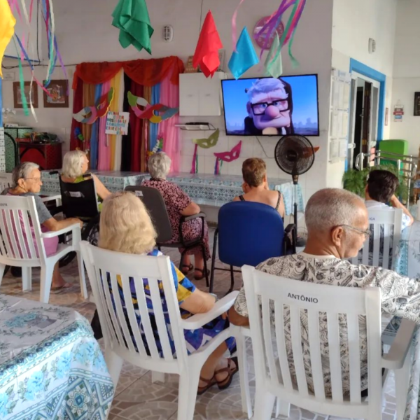 Grupo de idosos moradores do Residencial Longévité assistindo a uma sessão de cinema no residencial